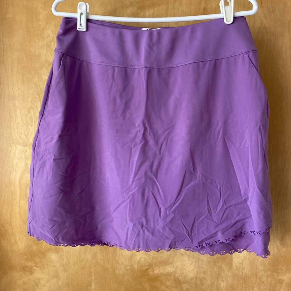 Greg Norman Purple golf skorts pair with four seasons resort golf shirt